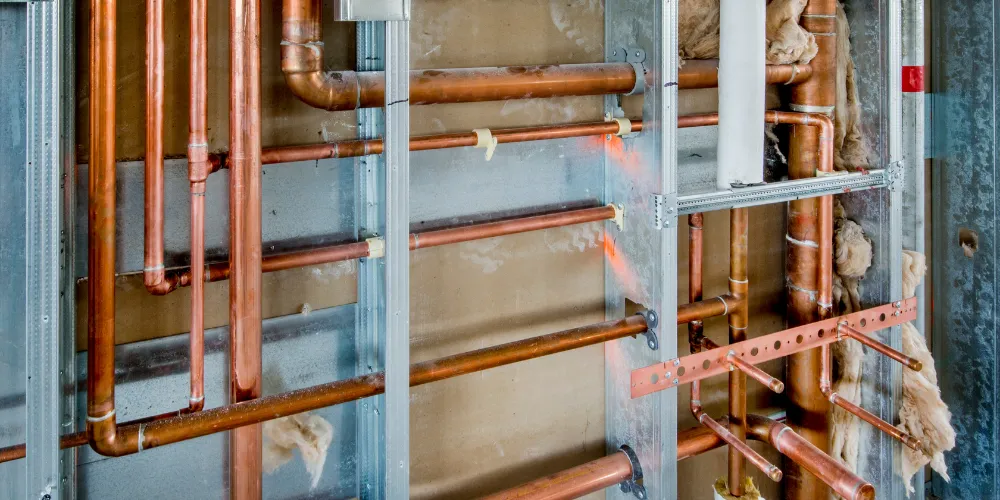 What causes a toilet to bubble when the shower is running upstairs?